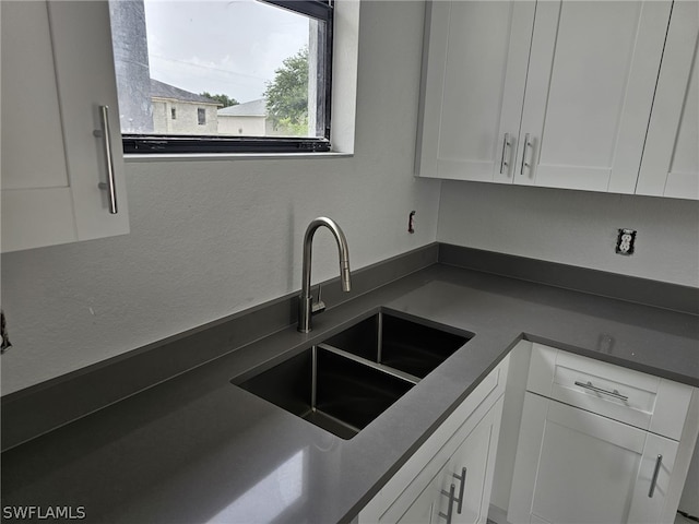 kitchen with white cabinetry and sink