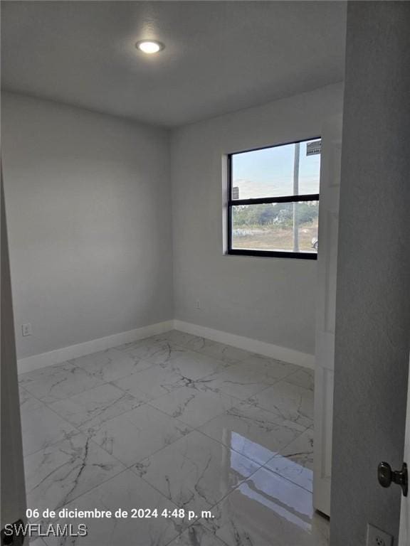 2801 48th St W, Lehigh Acres, FL 33971 - spare room with marble finish floor, baseboards, and recessed lighting
