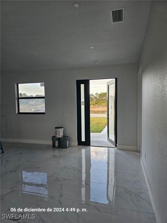 2801 48th St W, Lehigh Acres, FL 33971 - unfurnished room with visible vents, marble finish floor, and baseboards