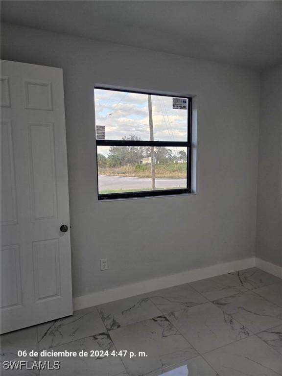2801 48th St W, Lehigh Acres, FL 33971 - unfurnished room with baseboards and marble finish floor