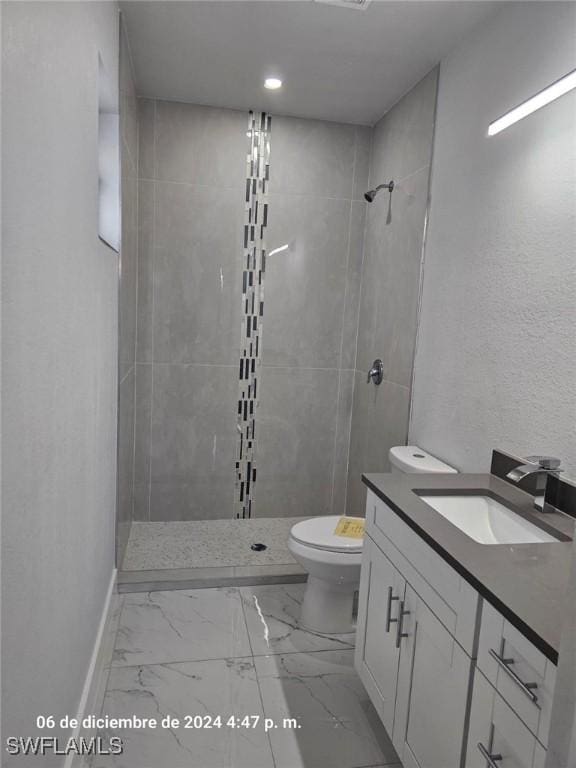2801 48th St W, Lehigh Acres, FL 33971 - full bath with vanity, marble finish floor, baseboards, toilet, and tiled shower