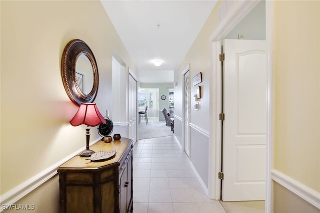 hall with light tile patterned floors