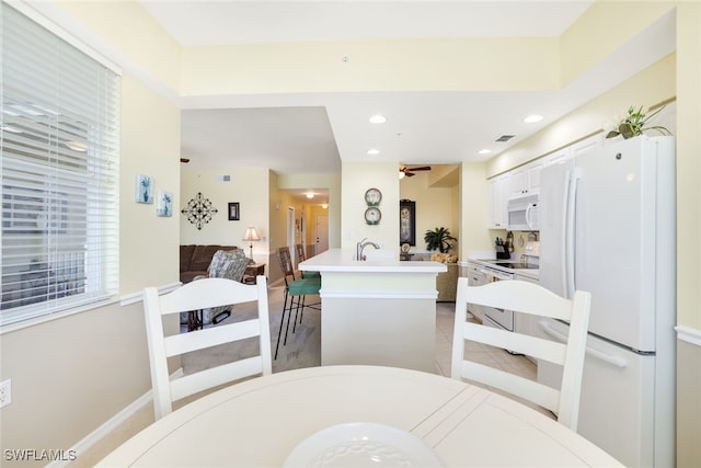 dining space with light tile patterned flooring and sink