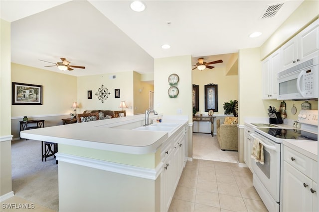 kitchen featuring sink, light carpet, ceiling fan, and white appliances