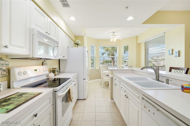 kitchen with white appliances, sink, light tile patterned floors, white cabinetry, and ceiling fan