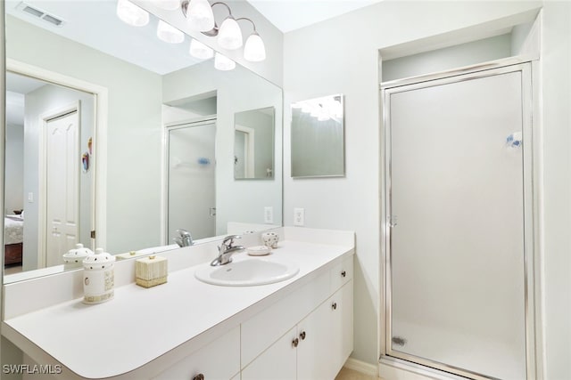 bathroom with walk in shower and vanity