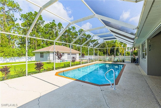 view of swimming pool featuring a patio area, glass enclosure, a lawn, and an outdoor structure