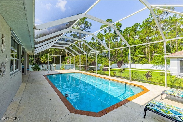 view of swimming pool with a lawn, a lanai, and a patio area