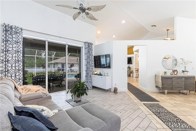 living room featuring ceiling fan and vaulted ceiling