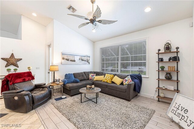 living room featuring lofted ceiling, light hardwood / wood-style floors, and ceiling fan