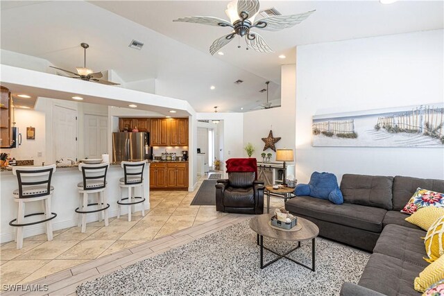 living room with ceiling fan and vaulted ceiling