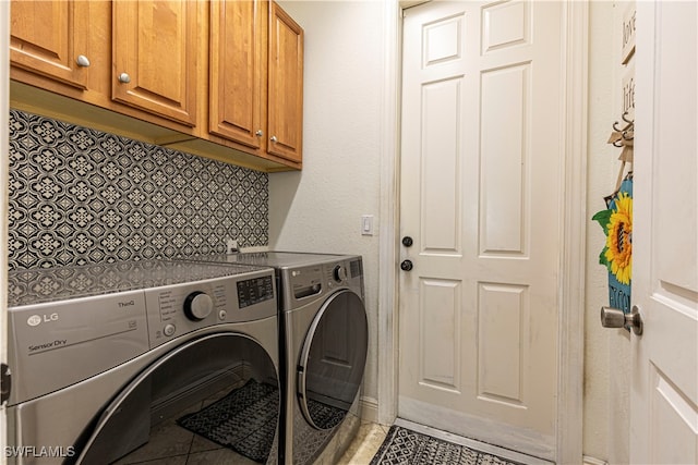 laundry area with cabinets, separate washer and dryer, and tile patterned floors