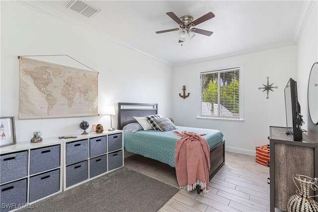 bedroom with hardwood / wood-style flooring, ornamental molding, and ceiling fan