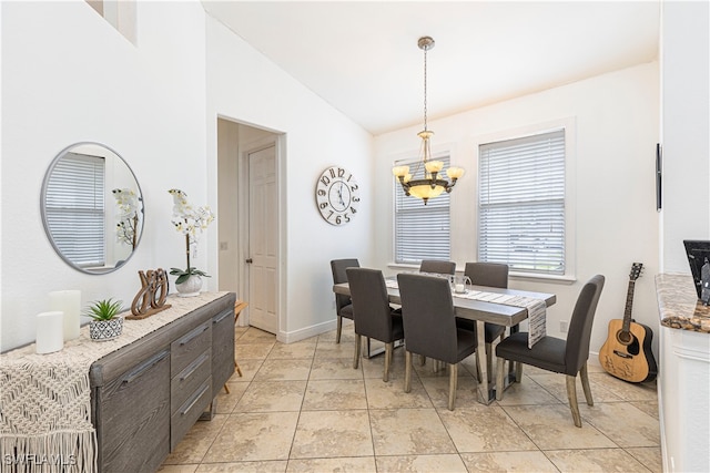 tiled dining room featuring an inviting chandelier and vaulted ceiling