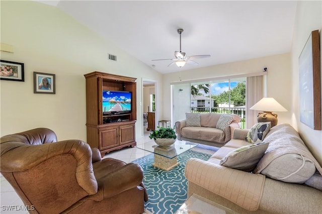 living room featuring a ceiling fan, lofted ceiling, visible vents, and light tile patterned floors