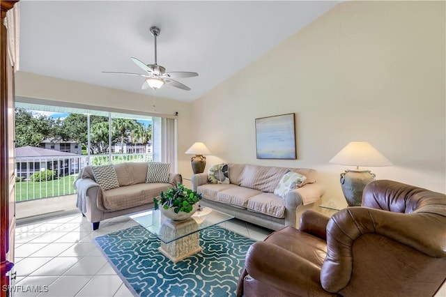 living room featuring lofted ceiling, light tile patterned floors, and ceiling fan