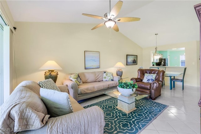 living area with light tile patterned floors, lofted ceiling, and a ceiling fan