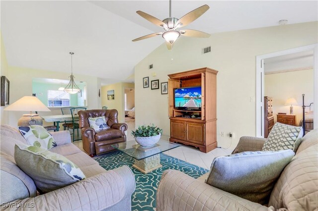 living room with tile patterned flooring, vaulted ceiling, and ceiling fan