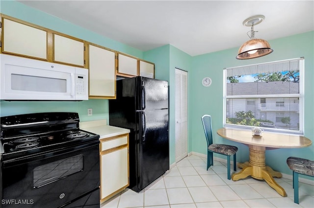 kitchen featuring white cabinetry, baseboards, light countertops, black appliances, and decorative light fixtures