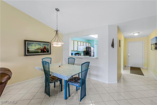 tiled dining room featuring sink