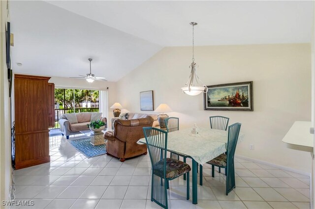 dining space with ceiling fan, lofted ceiling, and light tile patterned floors