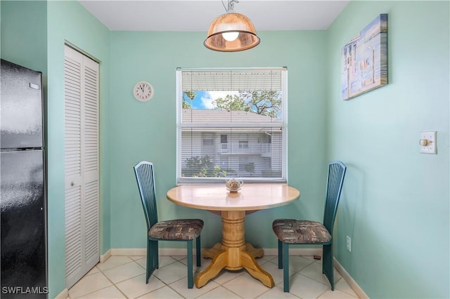 dining area with light tile patterned floors and baseboards