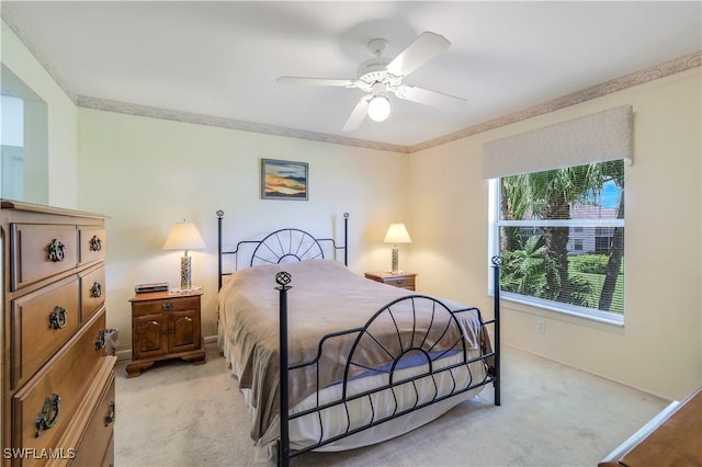 bedroom with light carpet, ceiling fan, ornamental molding, and baseboards