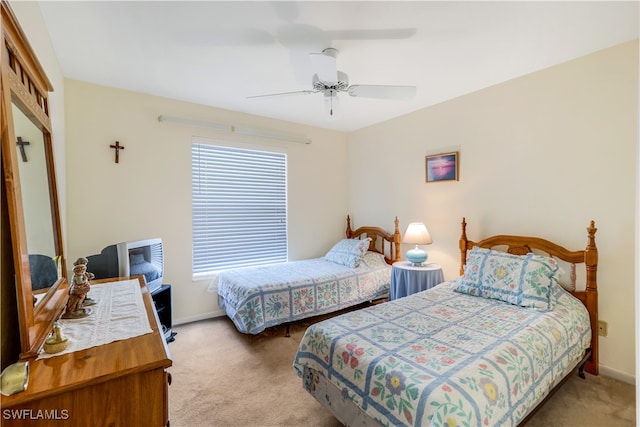 bedroom with light colored carpet, a closet, and ceiling fan