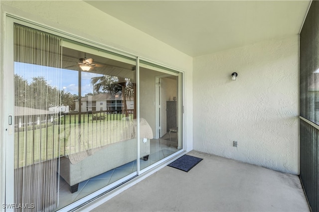 unfurnished sunroom featuring ceiling fan