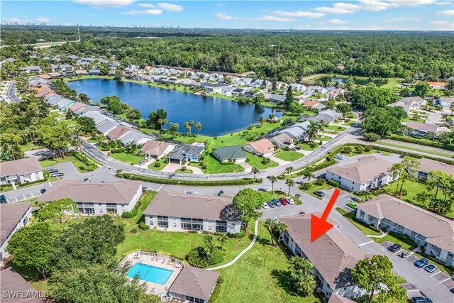 birds eye view of property with a water view, a wooded view, and a residential view