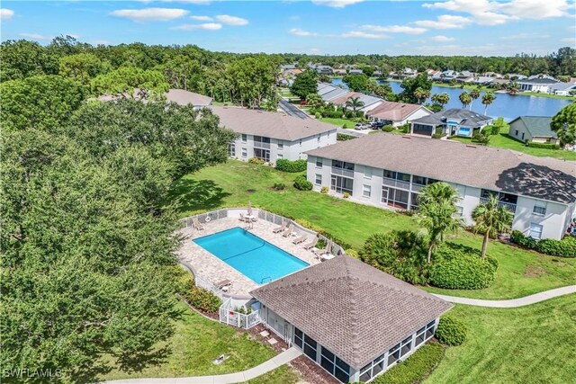 view of pool featuring a lawn