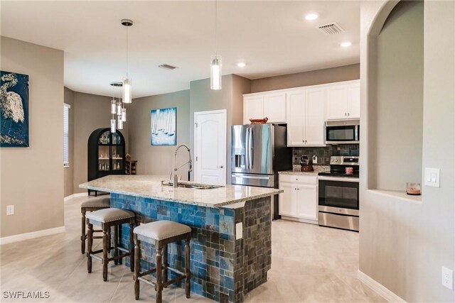 kitchen with light tile patterned flooring, white cabinetry, and appliances with stainless steel finishes