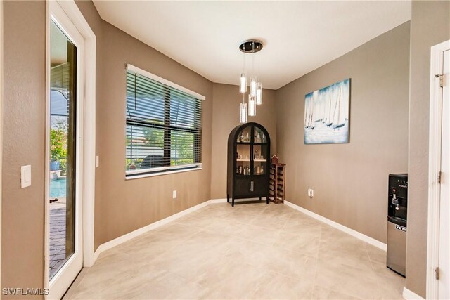 interior space featuring a chandelier and light tile patterned floors