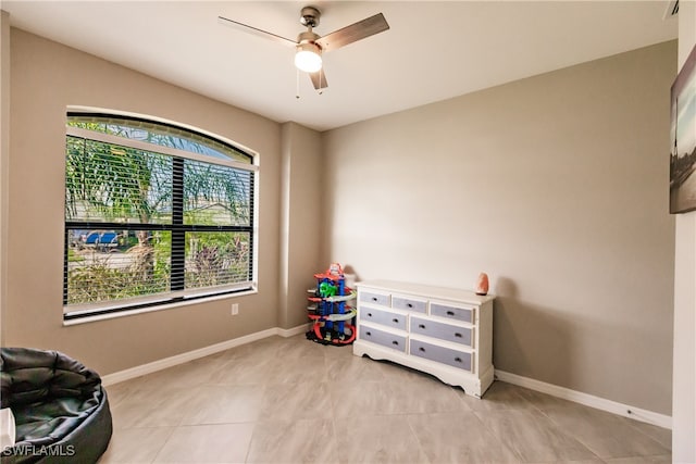 miscellaneous room with light tile patterned floors and ceiling fan