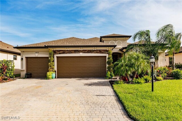 view of front facade with a garage and a front yard