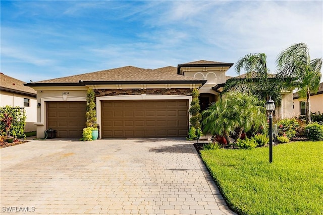 view of front of property with a garage and a front yard