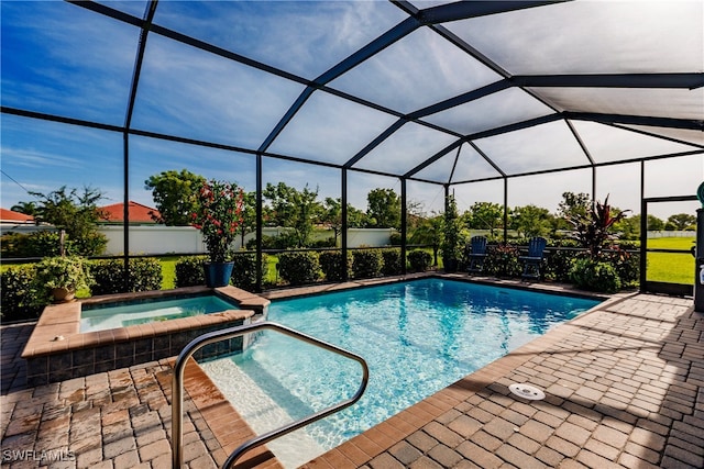 view of swimming pool featuring an in ground hot tub, a patio area, and glass enclosure