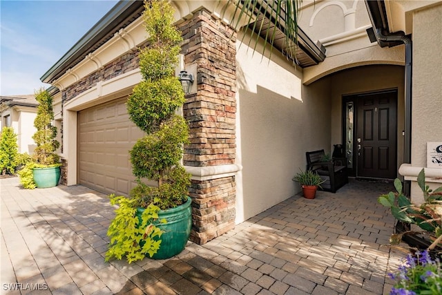 view of exterior entry featuring a garage