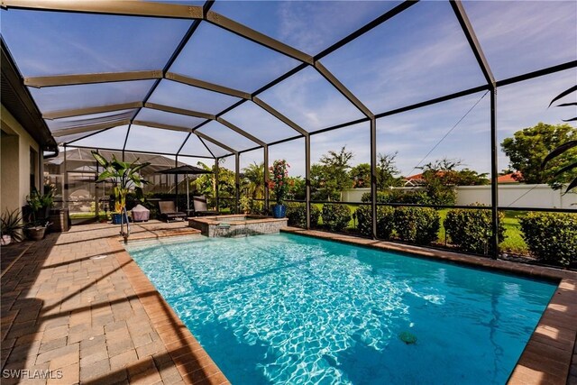 view of swimming pool featuring a patio, an in ground hot tub, and glass enclosure