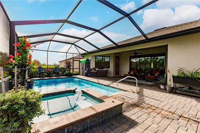 view of pool featuring an in ground hot tub, a lanai, a patio area, and ceiling fan