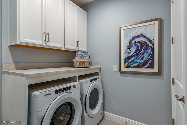 laundry room featuring cabinets and separate washer and dryer