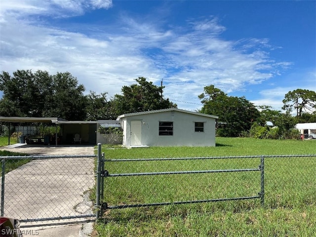 manufactured / mobile home with a carport and a front yard