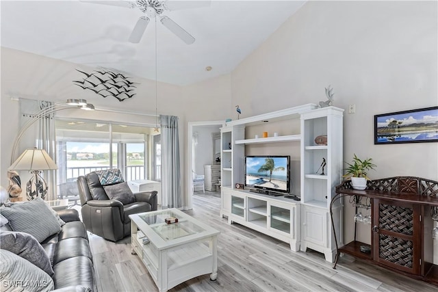 living room featuring ceiling fan, high vaulted ceiling, and light wood-type flooring