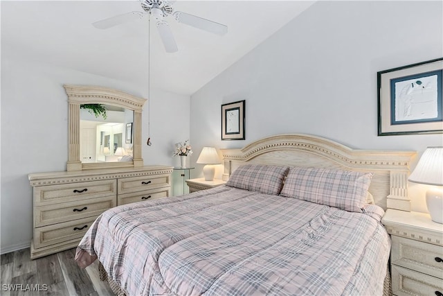 bedroom featuring vaulted ceiling, ceiling fan, and dark hardwood / wood-style flooring