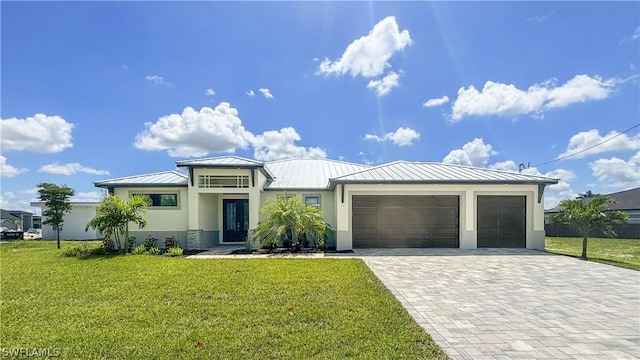 view of front of house with a front lawn and a garage