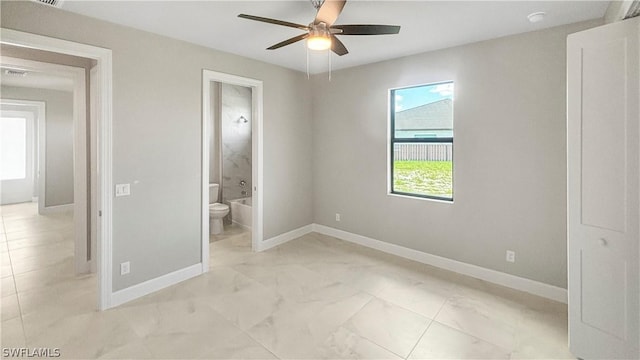 unfurnished bedroom featuring connected bathroom and ceiling fan