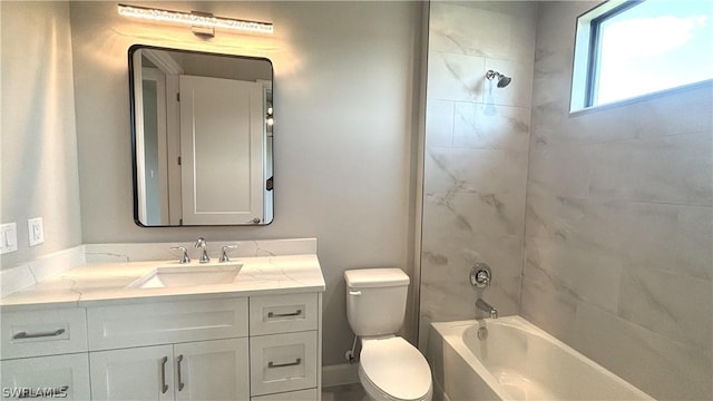 full bathroom with tiled shower / bath, vanity, and toilet