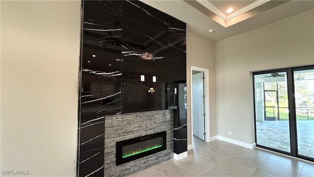 unfurnished living room with crown molding and a stone fireplace