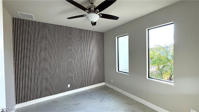 unfurnished room with ceiling fan