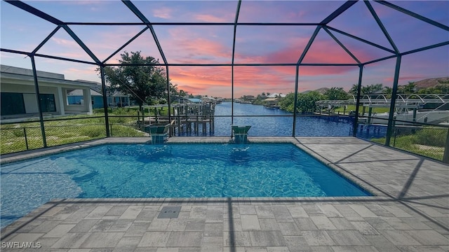 pool at dusk with a water view, a lanai, and a patio